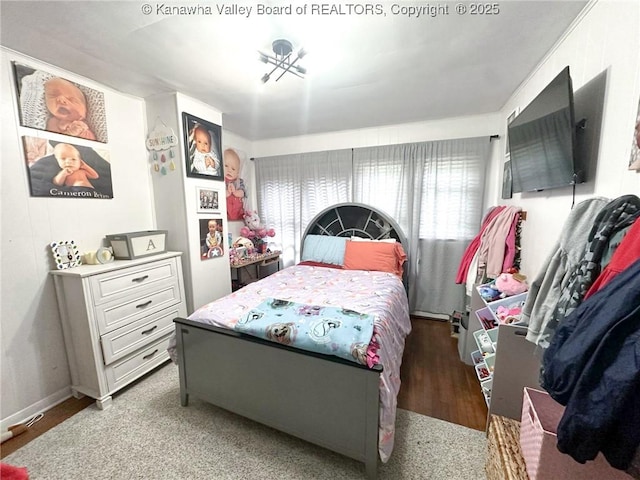 bedroom with baseboards and wood finished floors