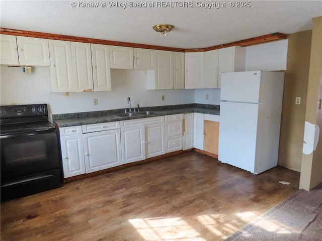 1908 Washington Ave, Saint Albans, WV 25177 - kitchen with freestanding refrigerator, electric range, a sink, dark wood finished floors, and dark countertops