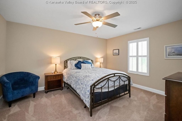 carpeted bedroom featuring baseboards and a ceiling fan