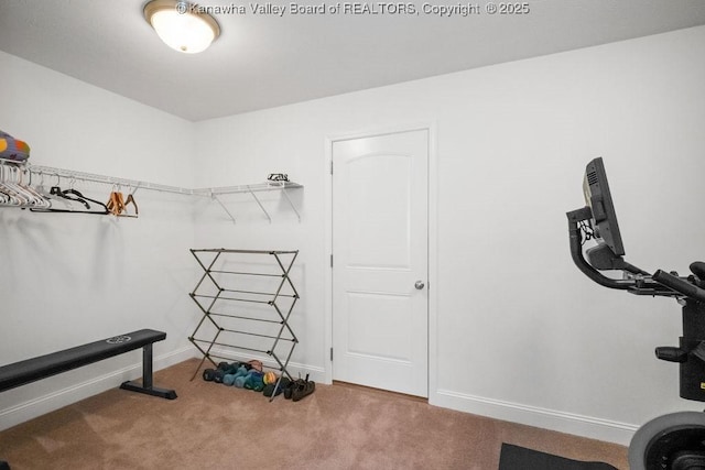 workout room with carpet and baseboards