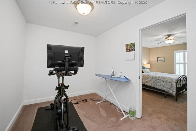 workout area featuring carpet floors, baseboards, and ceiling fan