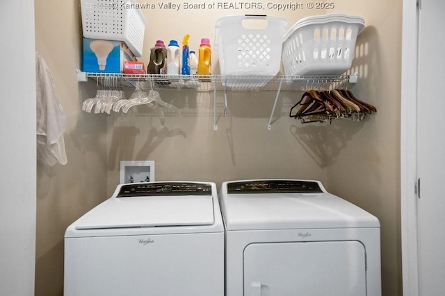 clothes washing area featuring washer and dryer