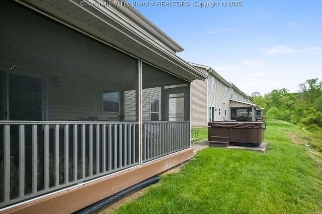 view of home's exterior with a hot tub and a lawn