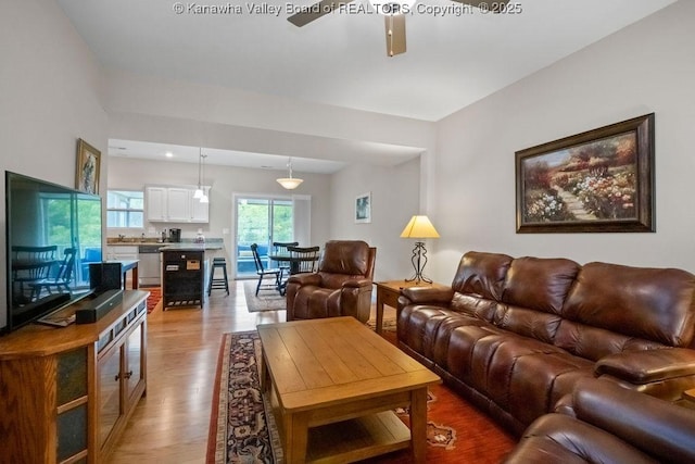 living room featuring light wood-style floors and ceiling fan