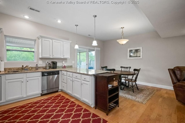 kitchen with dishwasher, a sink, light wood-style flooring, white cabinets, and recessed lighting