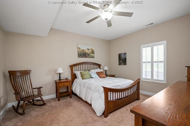 bedroom with light colored carpet, baseboards, and a ceiling fan