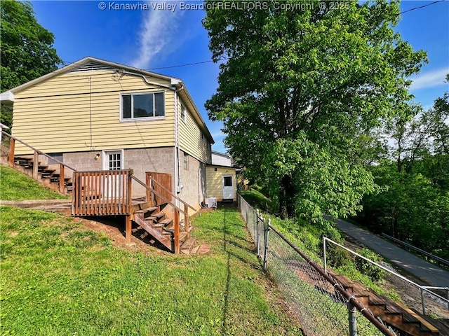 back of property with stairway and a wooden deck