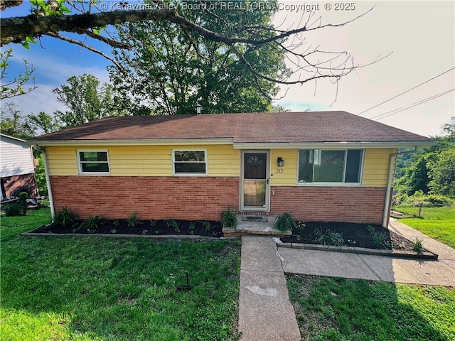 view of front of property with brick siding and a front yard