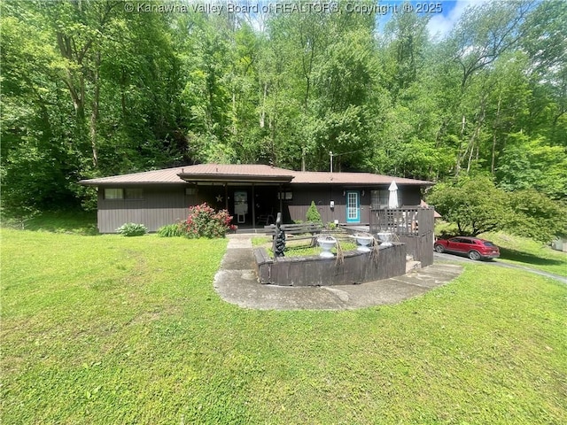 731 85th St, Marmet, WV 25315 - rear view of house with a yard, a wooded view, and metal roof