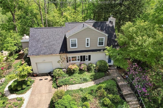 1518 Dogwood Rd, Charleston, WV 25314 - traditional home featuring concrete driveway, stucco siding, a shingled roof, an attached garage, and a chimney
