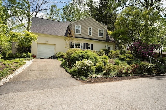 1518 Dogwood Rd, Charleston, WV 25314 - view of front of house with concrete driveway, stucco siding, a shingled roof, and a garage