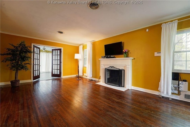 1518 Dogwood Rd, Charleston, WV 25314 - unfurnished living room featuring wood finished floors, a fireplace with raised hearth, crown molding, and baseboards