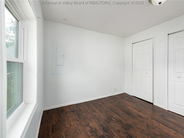 4 Main Ave, Nitro, WV 25143 - unfurnished bedroom with dark wood finished floors, baseboards, and multiple closets