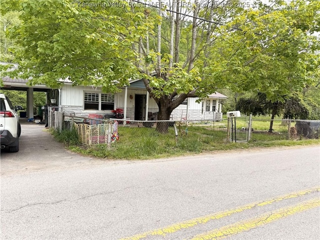 12027 Chap Rd, Wv, WV 25204 - obstructed view of property with a fenced front yard, board and batten siding, and a carport