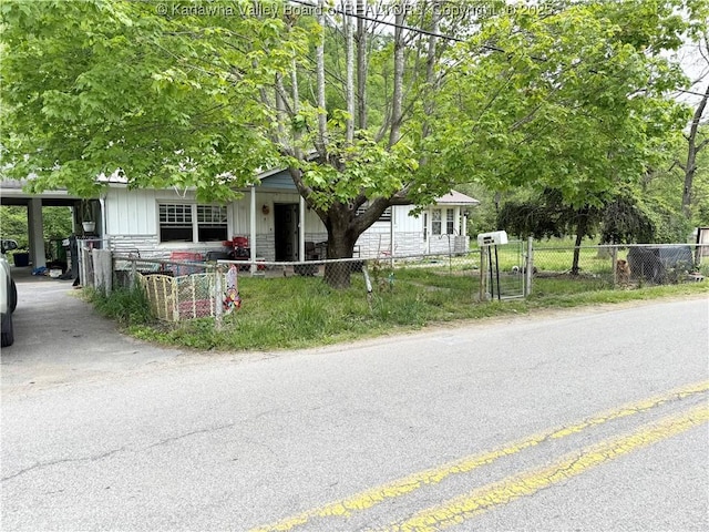 12027 Chap Rd, Wv, WV 25204 - view of property hidden behind natural elements with a fenced front yard and board and batten siding