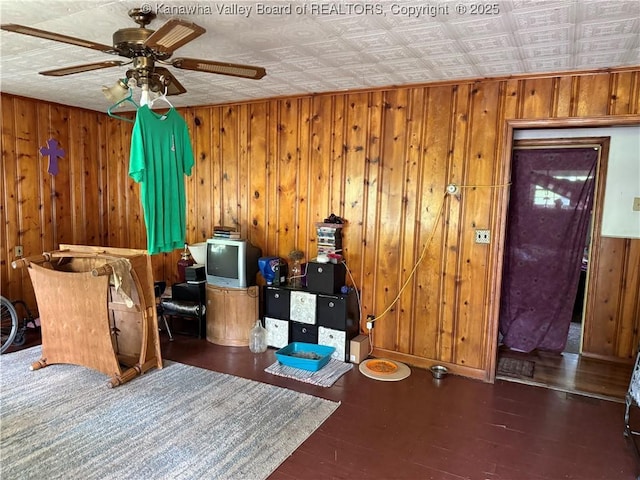 12027 Chap Rd, Wv, WV 25204 - living area with ceiling fan, wood finished floors, wooden walls, an ornate ceiling, and baseboards