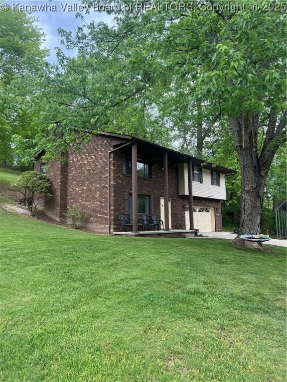 5222 Dalewood Dr, Charleston, WV 25313 - view of front of home featuring brick siding, an attached garage, a front yard, and driveway
