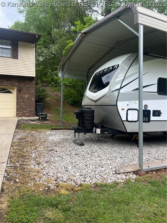 5222 Dalewood Dr, Charleston, WV 25313 - view of vehicle parking with a carport, driveway, and a garage