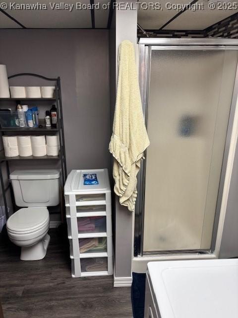 5222 Dalewood Dr, Charleston, WV 25313 - full bath with a stall shower, toilet, and wood finished floors