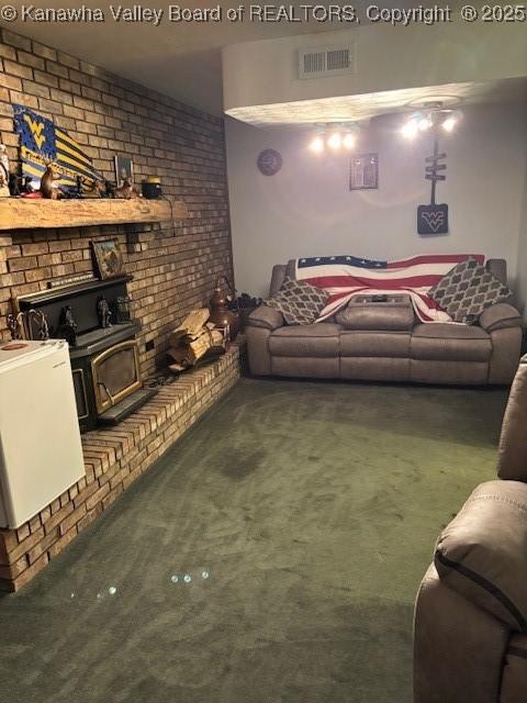 5222 Dalewood Dr, Charleston, WV 25313 - living room featuring carpet, a wood stove, and brick wall