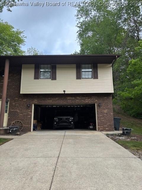 5222 Dalewood Dr, Charleston, WV 25313 - view of front facade featuring concrete driveway, a garage, and brick siding