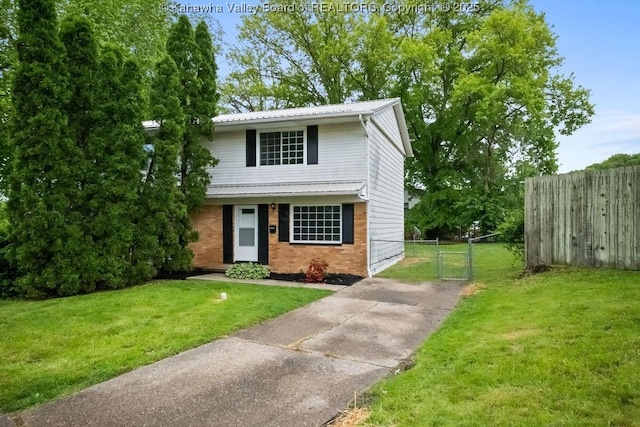 302 Charles Ct, Hurricane, WV 25526 - traditional home featuring brick siding, a gate, driveway, and metal roof