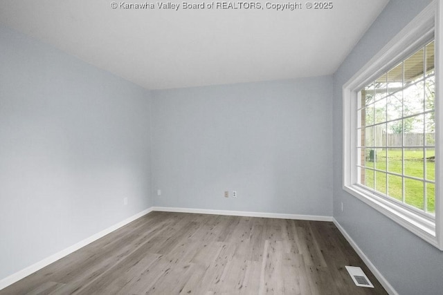 302 Charles Ct, Hurricane, WV 25526 - spare room with wood finished floors, plenty of natural light, and baseboards
