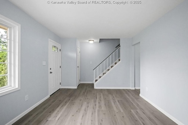 302 Charles Ct, Hurricane, WV 25526 - entrance foyer with wood finished floors, stairway, healthy amount of natural light, and baseboards