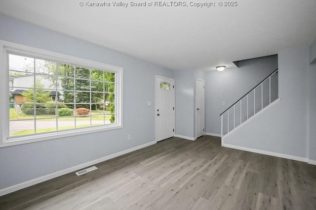 302 Charles Ct, Hurricane, WV 25526 - foyer entrance with baseboards, stairs, and wood finished floors