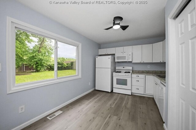 302 Charles Ct, Hurricane, WV 25526 - kitchen featuring white appliances, baseboards, wood finished floors, and white cabinetry