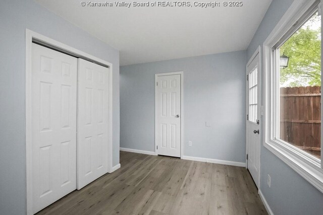 302 Charles Ct, Hurricane, WV 25526 - unfurnished bedroom with wood finished floors, baseboards, and a closet