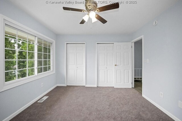 302 Charles Ct, Hurricane, WV 25526 - unfurnished bedroom with multiple closets, carpet flooring, baseboards, and a ceiling fan