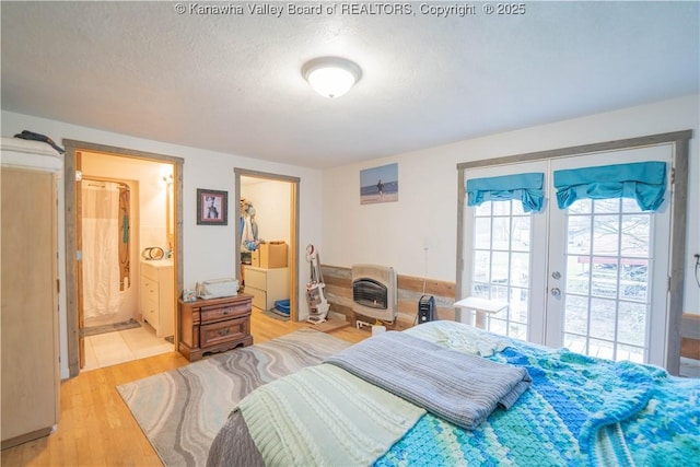 28 Tracy Ln, Summersville, WV 26651 - bedroom with french doors, light wood-style floors, ensuite bathroom, access to outside, and a textured ceiling