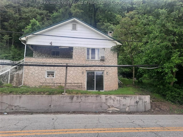 view of home's exterior featuring a forest view