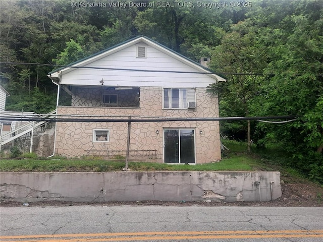 view of property exterior featuring a wooded view