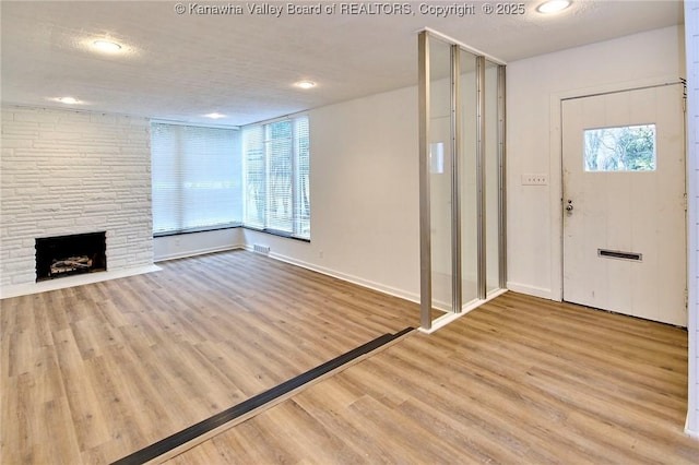 4010 Virginia Ave SE, Charleston, WV 25304 - entrance foyer featuring wood finished floors, a fireplace, recessed lighting, and baseboards