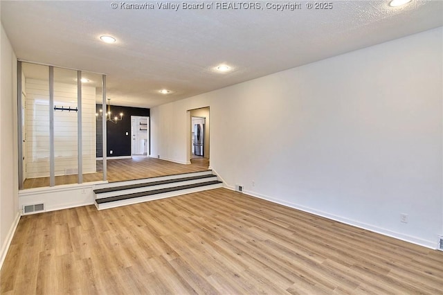 4010 Virginia Ave SE, Charleston, WV 25304 - empty room with wood finished floors, recessed lighting, baseboards, and a chandelier
