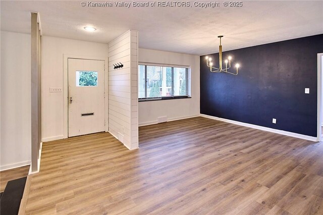 4010 Virginia Ave SE, Charleston, WV 25304 - foyer with a chandelier, healthy amount of natural light, baseboards, and wood finished floors