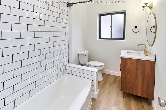 4010 Virginia Ave SE, Charleston, WV 25304 - bathroom with a tub, toilet, wood finished floors, and vanity