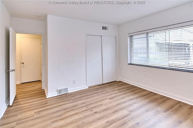 4010 Virginia Ave SE, Charleston, WV 25304 - unfurnished bedroom featuring light wood-style flooring, a closet, and baseboards