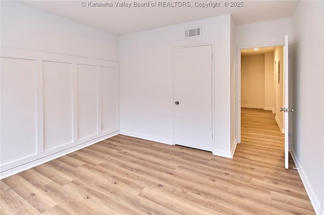 4010 Virginia Ave SE, Charleston, WV 25304 - unfurnished bedroom with light wood-style floors, a closet, and baseboards