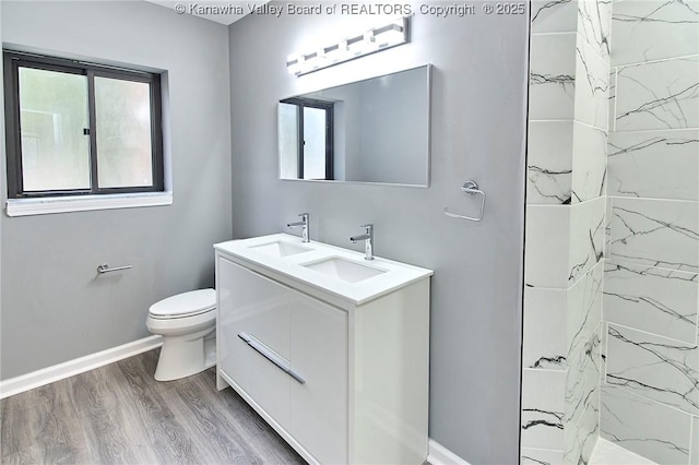 4010 Virginia Ave SE, Charleston, WV 25304 - bathroom with wood finished floors, healthy amount of natural light, baseboards, and toilet