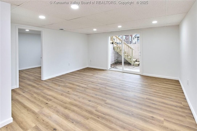 4010 Virginia Ave SE, Charleston, WV 25304 - spare room with light wood-type flooring, baseboards, stairs, and a paneled ceiling