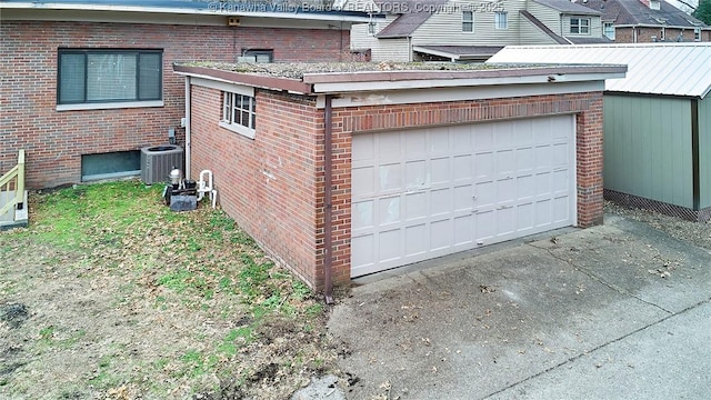4010 Virginia Ave SE, Charleston, WV 25304 - view of side of property with central AC, a garage, brick siding, and driveway
