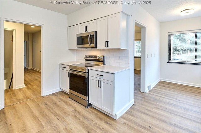 4010 Virginia Ave SE, Charleston, WV 25304 - kitchen with appliances with stainless steel finishes, light countertops, light wood-style floors, and baseboards