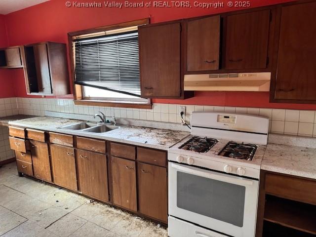 311 1/2 Westmoreland Dr, Charleston, WV 25302 - kitchen featuring under cabinet range hood, white range with gas stovetop, a sink, light countertops, and tasteful backsplash
