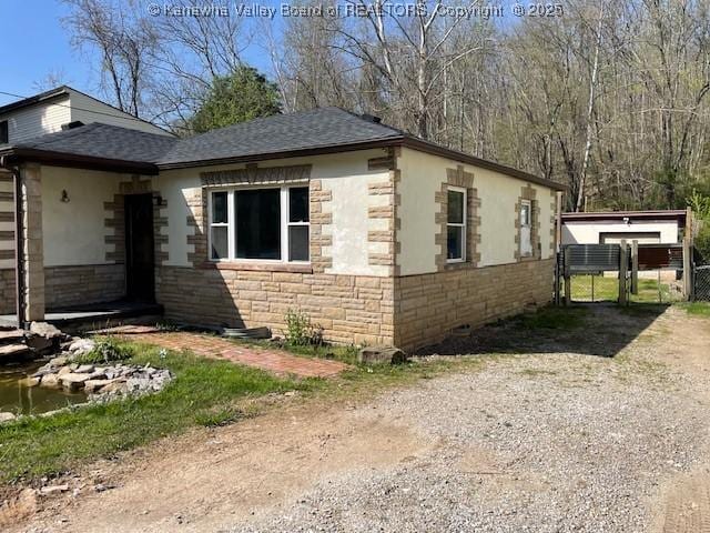 4866 Washington St W, Charleston, WV 25313 - view of home's exterior featuring a gate, stone siding, a shingled roof, and driveway