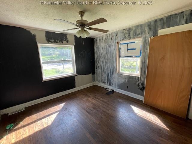 4866 Washington St W, Charleston, WV 25313 - empty room with baseboards, healthy amount of natural light, wood finished floors, a textured ceiling, and ceiling fan