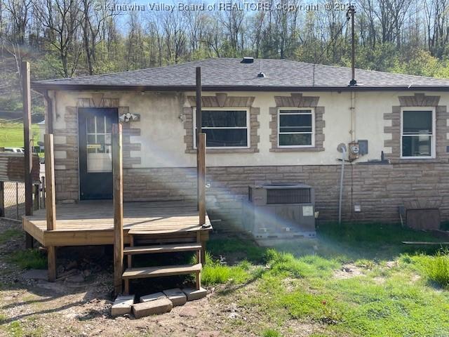 4866 Washington St W, Charleston, WV 25313 - back of house featuring a wooden deck, stone siding, and roof with shingles