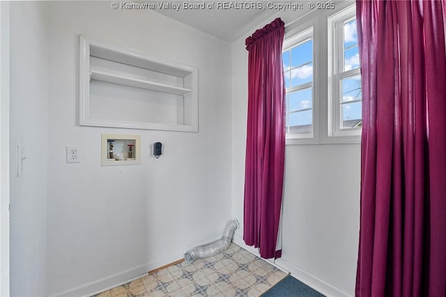 laundry area featuring washer hookup and baseboards